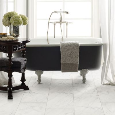 marble tile floors in a bright bathroom with tub